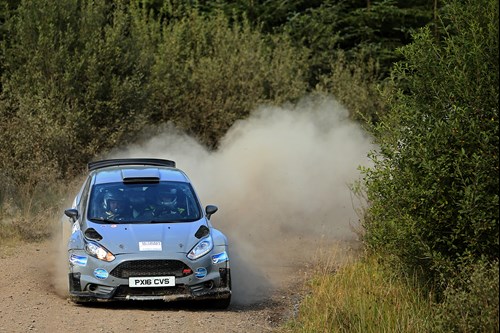 Ni Rally Championship - car skids round corner on dusty track