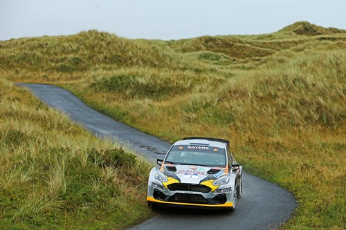 Gareth Swayers takes a bend in the road on a scenic mountainous route as part of the ni rally.