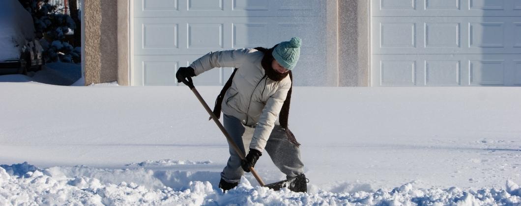 Happy customer shovelling snow safely 