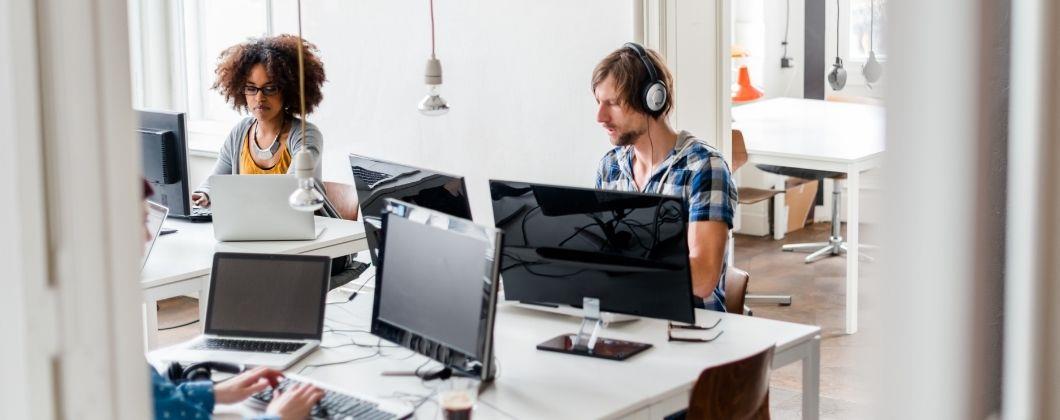 Young people at work in a busy insurance office