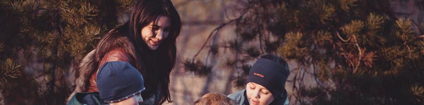 Family playing with a dog, covered by personal insurance