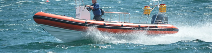 Happy customer sailing on a speed boat, covered by boat insurance