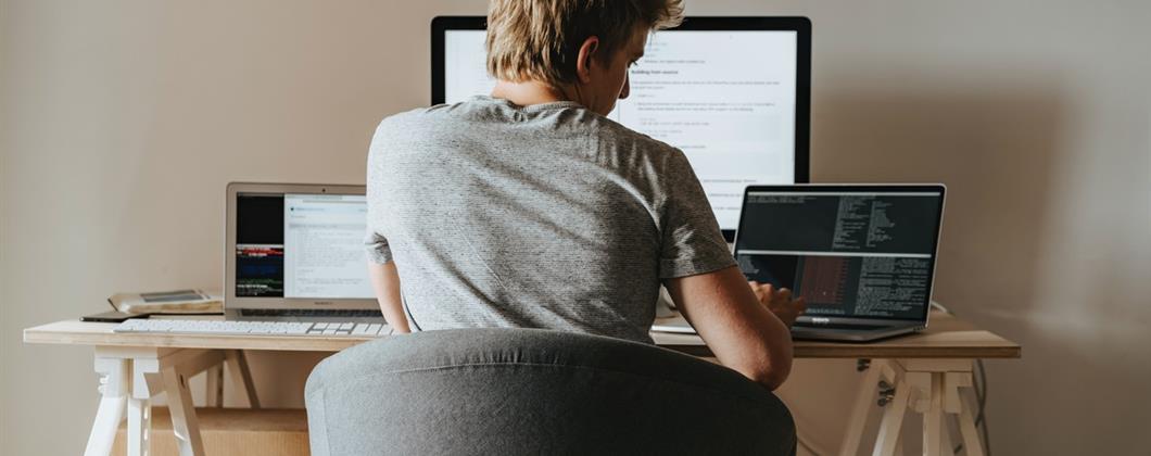 Insurance worker using laptop remotely to read Health and Safety Programmes